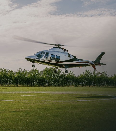 Helicopter in flight above woodland