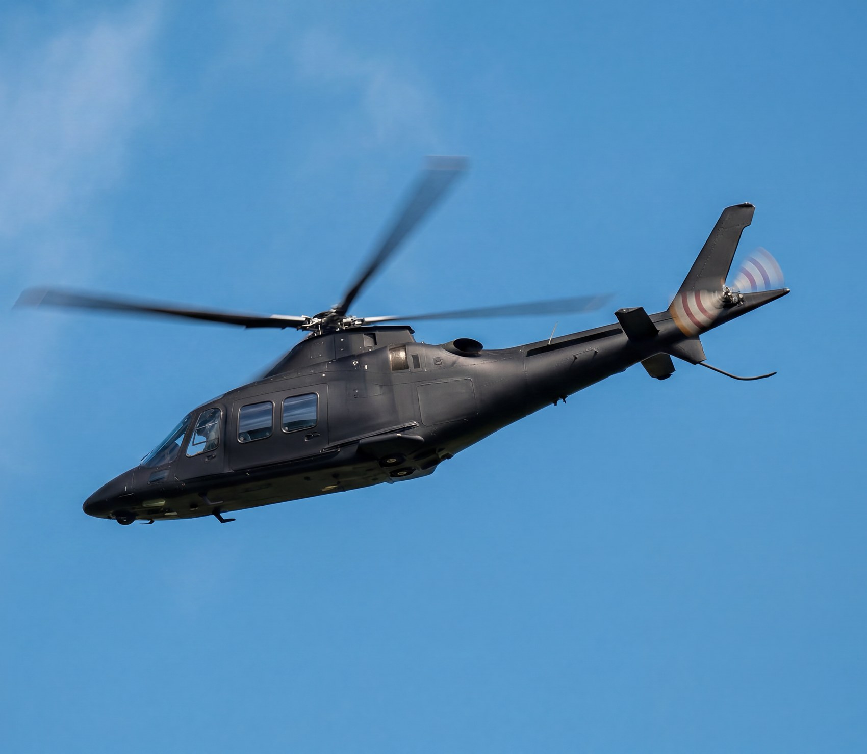 Helicopter in flight against a clear blue sky