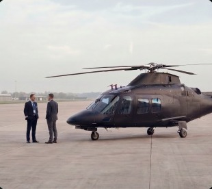 Two passengers standing beside a helicopter
